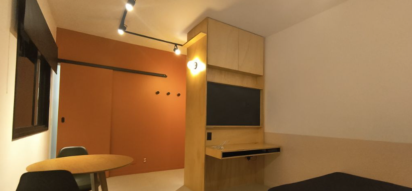 a small room with a desk and a chair